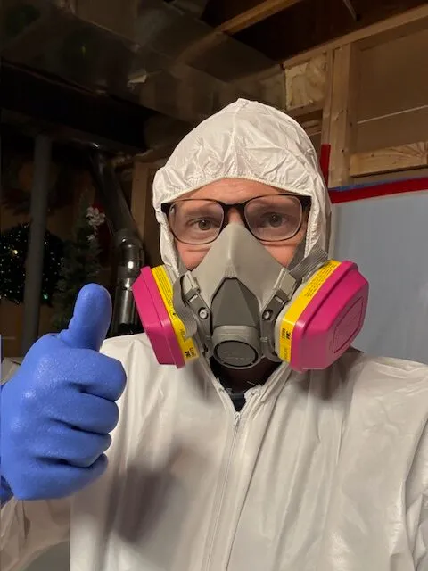 Mold remediation technician in protective gear